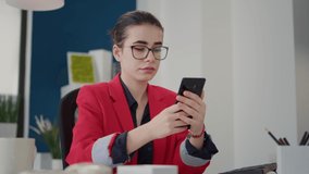 Company accountant checking text message on smartphone after working on business growth. Sales consultant browsing internet on phone, planning financial marketing strategy in office. - Powered by Shutterstock - Get 15% off with code: PIKWIZARD15