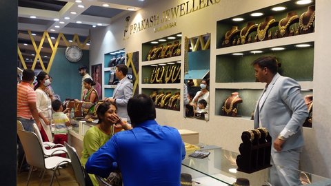 Bangalore, India 4th May 2022: Indian customers in a jewellery exhibition to buy gold. Traditional Ornaments on Display. Beautiful jewelry on display at a jewelry store in the exhibition.