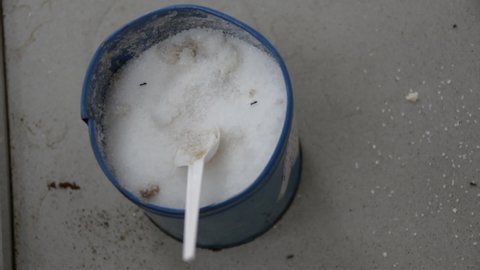 Sugar can with white spoon and ants
