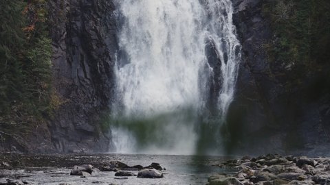 Storfossen waterfall in Norway. A powerful flow of white water falls on the black rocks. Slow-motion, long exposure.