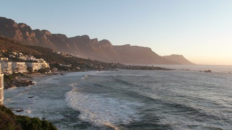 Beautiful Sunrise Over Clifton Beach With Coastline Buildings, Houses, And Mountains Backdrop In Cape Town, South Africa - Wide Shot