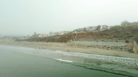 People on a foggy day at the beach in California coastline (Avila beach)