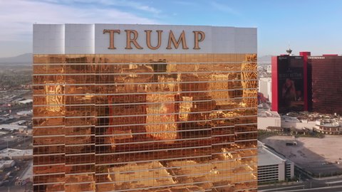 Las Vegas Strip, Nevada. Beautiful shiny golden Trump resort hotel with epic Las Vegas city reflection on motion background. Scenic view on world famous 5 stars hotel in golden hour light, Apr. 2022