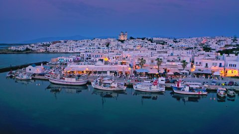 Greece island Paros tavernas and boats in harbor bay aerial evening view