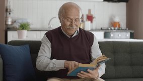 An old man reading a book in his peaceful home, enjoying his free time. Happy seniors, retired woman concept. Concept of love for reading books. - Powered by Shutterstock - Get 15% off with code: PIKWIZARD15