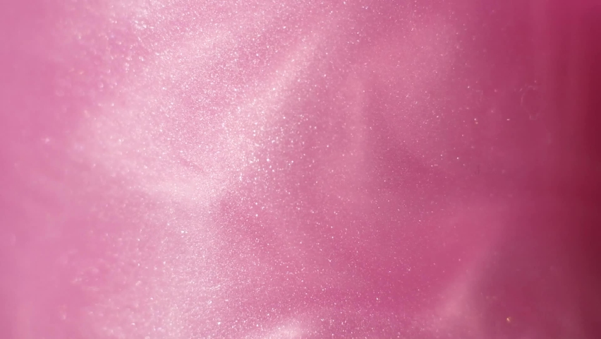 Glittering abstract pink background. Color fluid is swirling in beautiful silver clouds. Glitter dust is moving slowly in water. Amazing abstract texture background. Royalty-Free Stock Footage #1089968601