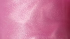 Glittering abstract pink background. Color fluid is swirling in beautiful silver clouds. Glitter dust is moving slowly in water. Amazing abstract texture background. - Powered by Shutterstock - Get 15% off with code: PIKWIZARD15