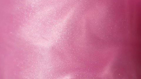 Glittering abstract pink background. Color fluid is swirling in beautiful silver clouds. Glitter dust is moving slowly in water. Amazing abstract texture background. Stockvideo