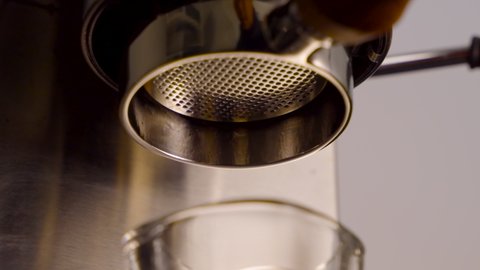Close up slow motion of Pouring coffee stream from professional machine , Crema Espresso Perfect Shot from coffee maker machine