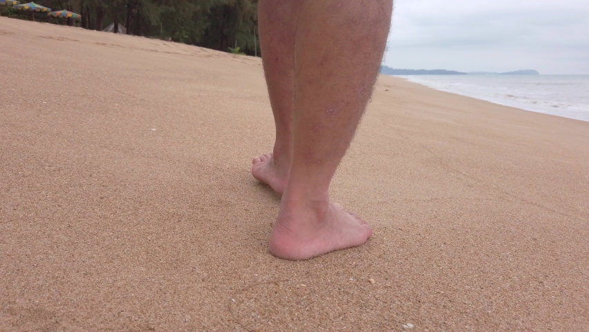POV of man walking with barefoot on white sand beach in slow-motion in summer holiday vacation | Shutterstock HD Video #1089971559