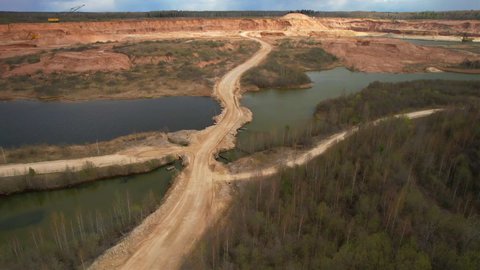 Mining truck transports limestone from opecast, drone view. View of an open pit for extraction of dolomite and limestone. Anthropogenic landscape in open-pit mining. Haul truck in quarry. 