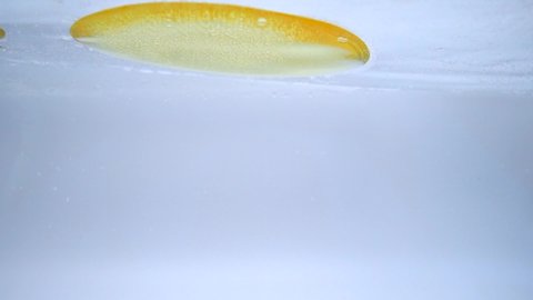 Slow Motion Yellow oil floating on water Surface.