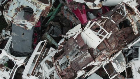 Car scrap yard. Aerial shot, pile of crushed and destroyed cars for recycling purposes