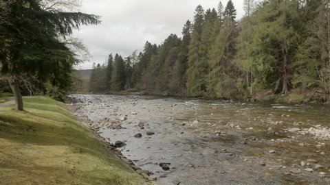 The River Dee flowing through the Queen of Englands summer residence at Balmoral Scotland.