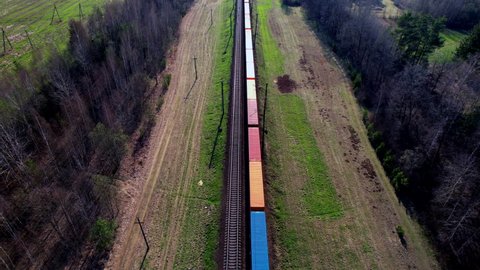 Shipping containers transportation on freight train by railway. Cargo Containers On Railroad. Intermodal Container On Train Car. Rail Freight Shipping Logistics. Multimodal Freight Transportation.