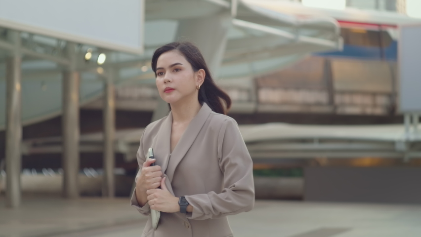 A young beautiful businesswoman is walking in Modern city , city lifestyle concept

