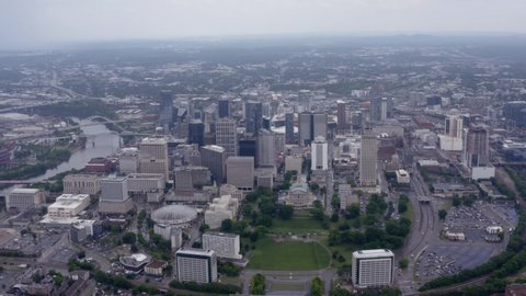 Nashville, Tennessee, USA - May 6 2022: High aerial drone angle above Downtown Nashville skyline. Cloudy day. 