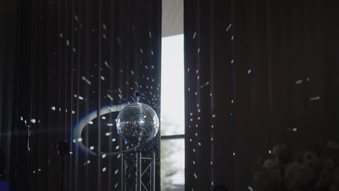 Sparkling disco ball with bright rays. Colorful blurred laser lights. Slow motion professional color lighting and sound show effects. Background of concert light flashes. Party, club.