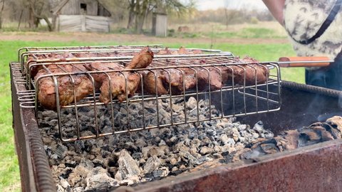 Close-up of grilling dish on barbecue. Barbecue grilling shish. Charcoal cooked meat. Delicious food on metal skewer in bbq. Time to picnic concept. Food festival. Pork at the stake. Fried pork