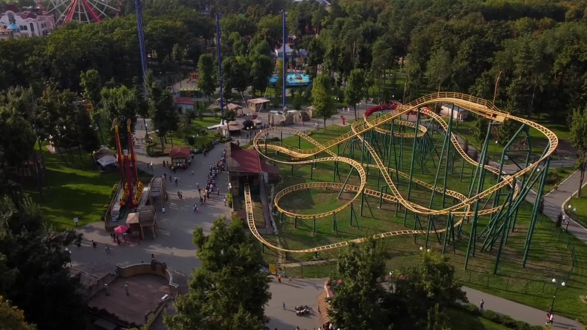 Amusement park in the city of Kharkov (Ukraine). A wonderful summer day, visitors to the park ride on various extreme attractions