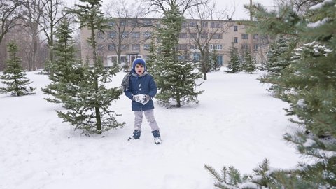 Brother and sister play snowball at winter