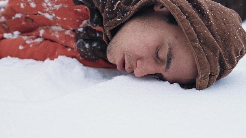 Unconscious man lies on the snow Royalty-Free Stock Footage #1089991791