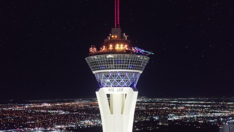 Scenic aerial around STRAT hotel with rides on SkyPod observation deck with epic views on night Las Vegas. Breathtaking night sky on motion background of Stratosphere Tower, Las Vegas USA, Apr. 2022