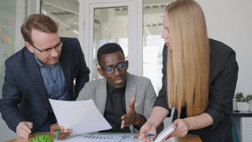 Diverse business team, african man has argument with his caucasian colleagues partners, rejecting their offer and report, looking for solution, hard emotional negotiations, project cancelling - Powered by Shutterstock - Get 15% off with code: PIKWIZARD15