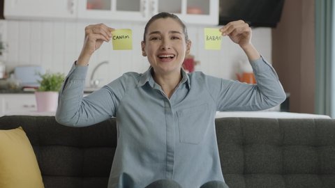 Message video of a happy woman holding paper notes with "dear dad" in Turkish over her eyes. Valentine's Day, mother's day, father's day, romantic concept.