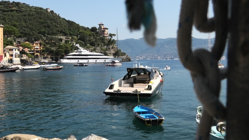 Yachts in the port of the quiet village of Portofino, Italy with ship chain in the front