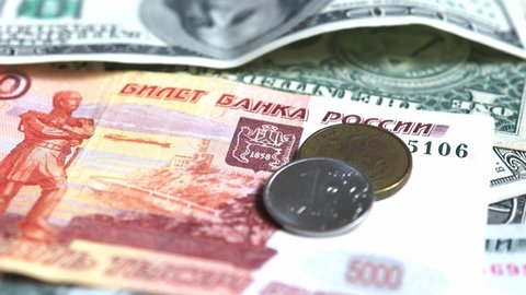 Close-up of Russian rubles and US dollars. Financial crisis, ruble devaluation concept.