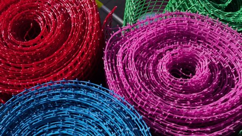 Several colored rolls of plastic mesh are in the store.
