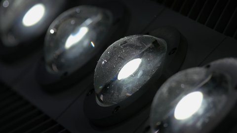 Close-up of turning on diode LED lights. Semisphere reflective glass lamps.