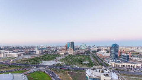 Elevated view over the city center and central business district from day to night transition timelapse rooftop, Central Asia, Kazakhstan, Astana