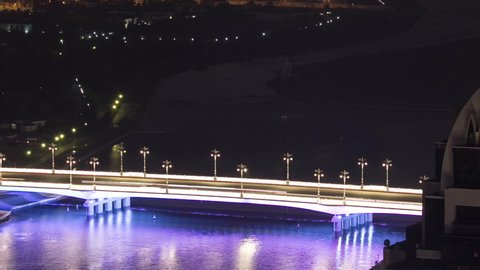 River and illuminated bridge aerial timelapse from rooftop at night in Astana. Nur-Sultan city, Kazakhstan capital