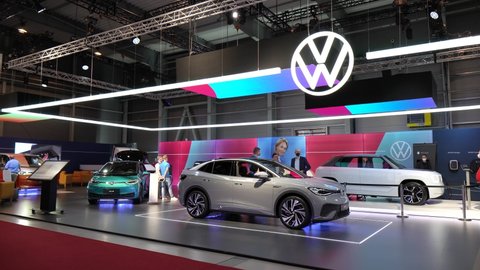 PRAGUE, CZECH REPUBLIC - NOVEMBER 14, 2021: New models (gray VW ID.5, white VW ID. Life and turquoise VW ID.3) in the Volkswagen section at a car exhibition - people walk around