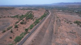 Aerial view of a freight train hauled by twin diesel locomotives at Adarki amidst nature near Pune India.