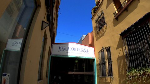 Sevilla, Spain, September 12, 2021: DOLLY SHOT - The entrance to the Mercado de Triana, an indoor market in the Triana district area of the Andalusian city of Seville.