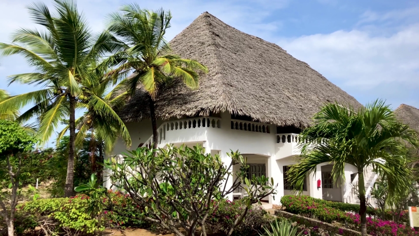 Typical house in the coast of Watamu beach in Kenya. Holiday house with garden by the sea. White beach, palm trees and lush vegetation.