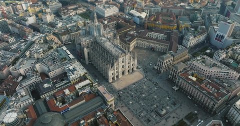 Milan, Italy. April 10, 2022. Aerial view of Milan city from above. Flying over Milan city center with people walking down the narrow streets of Milan and Duomo di Milano cathedral.