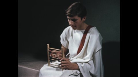 1950s 100 BC: Boy sits, moves beads on abacus, concentrates. Arches, aqueduct over river. Man wears toga, walks up to statue. Man pulls bucket of water from well.
