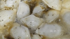cooking dumplings in a saucepan closeup video