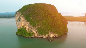 Aerial sunset above mountain silhouette. Beautiful views of the Andaman Sea. “Underwater Wedding Beach” Trang, Thailand. 4k drone footage
