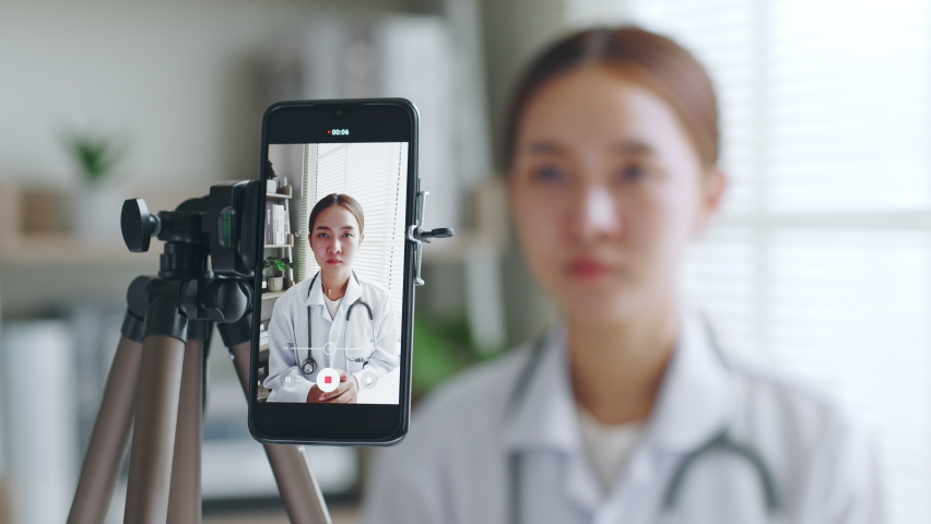 Asian woman doctor making online live streaming broadcast talking over camera recording in hospital, medical and healthcare blogger, vlogger concept Royalty-Free Stock Footage #1090015759