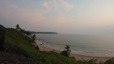 4K Wide angle time lapse of beach as seen from cliff above the Cabo De Rama beach at Goa in India. Time lapse of sunset at the beach. Nature Beach background. Summer holidays. Ocean wave background. 
