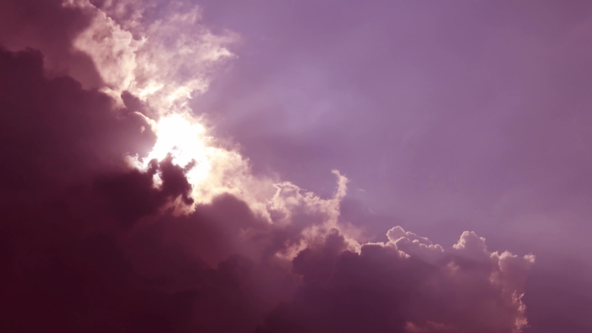 Bright sun light ray flare n spectrum sunbeam shining through puffy cloud n cumulus cloudscape in tropical summer sunlight n sunray at sunrise or sunset pastel purple pink sky, 4k b-roll TimeLapse Royalty-Free Stock Footage #1090017009