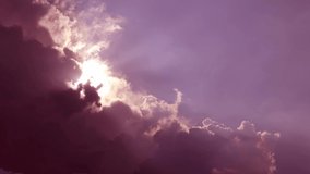 Bright sun light ray flare n spectrum sunbeam shining through puffy cloud n cumulus cloudscape in tropical summer sunlight n sunray at sunrise or sunset pastel purple pink sky, 4k b-roll TimeLapse