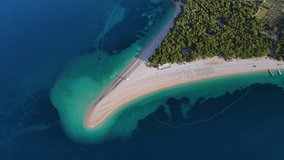 Aerial view of Zlatni Rat beach in Adriatic sea on Brac island, Dalmatia, Croatia. 4k drone video. Summer vacation resort