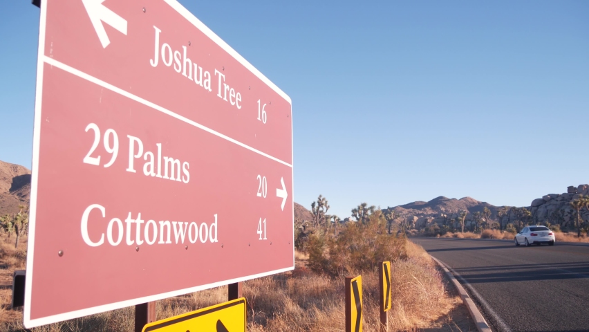 Crossroad sign with direction arrows on road intersection, California USA. Travel destination for trip on vacations. Joshua Tree national park, desert wilderness. Hitchhiking traveling in yucca valley