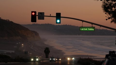 Traffic lights on pacific coast highway 1, Torrey Pines state beach, Del Mar, San Diego, California USA. Coastal road trip vacations. Roadtrip on freeway 101 along ocean. Cars in evening twilight dusk